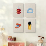 The four Desk Essentials mini canvases on a wall above a shelf