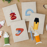 The four finished Desk Essentials mini canvases laid out on a table