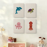 The four Dolphin and Squid mini canvases on a wall above a shelf