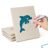 Hand punching one of the Dolphin and Squid mini canvases