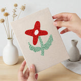 Hand holding a finished Doodle Flowers mini canvas