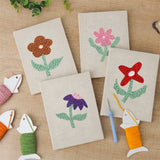 The four finished Doodle Flowers mini canvases laid out on a table