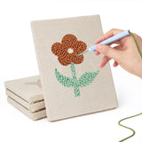 Hand punching one of the Doodle Flowers mini canvases