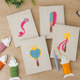 The four finished Dress Up Favorites mini canvases laid out on a table