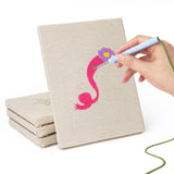 Hand punching one of the Dress Up Favorites mini canvases
