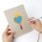 Punching a Dress Up Favorites mini canvas with the punch needle