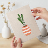 Hand holding a finished Dried Stem Vases mini canvas