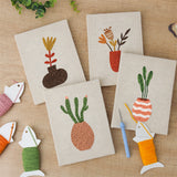 The four finished Dried Stem Vases mini canvases laid out on a table