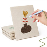 Hand punching one of the Dried Stem Vases mini canvases