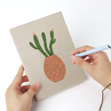 Punching a Dried Stem Vases mini canvas with the punch needle
