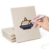 Hand punching one of the Drumstick Dinner mini canvases