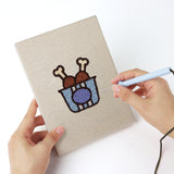 Punching a Drumstick Dinner mini canvas with the punch needle