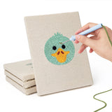Hand punching one of the Duck and Walrus mini canvases