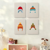 The four Earflap Winter Hats mini canvases on a wall above a shelf