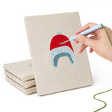 Hand punching one of the Earflap Winter Hats mini canvases