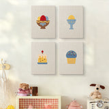 The four Easter Table Treats mini canvases on a wall above a shelf
