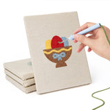 Hand punching one of the Easter Table Treats mini canvases