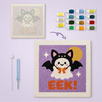 Eek Bat Ghost canvas before and after punching, with the threads and tools