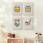 The four Egg Basket Spring mini canvases on a wall above a shelf