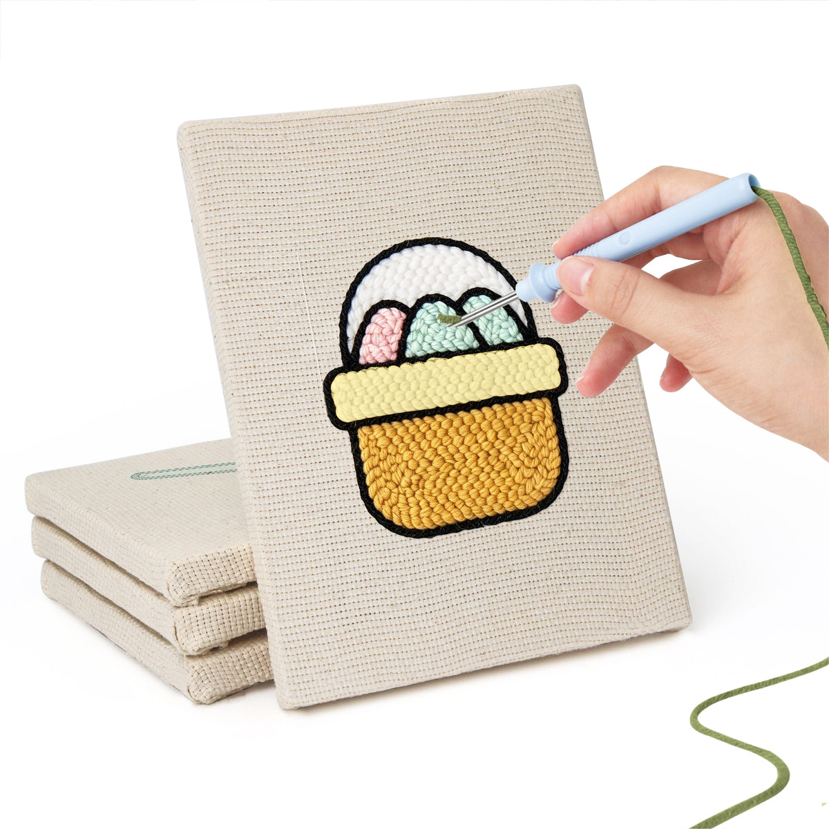 Hand punching one of the Egg Basket Spring mini canvases