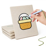 Hand punching one of the Egg Basket Spring mini canvases