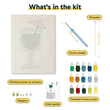 What is in the Emerald Cocktail Glass kit: printed canvas, punch needle, threader, threads, color guide and hangers