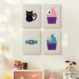 The four Eyeball Cupcakes mini canvases on a wall above a shelf