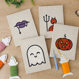 The four finished Fangs and Ghost mini canvases laid out on a table