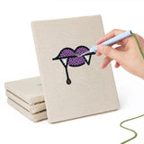Hand punching one of the Fangs and Ghost mini canvases