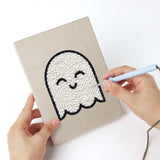 Punching a Fangs and Ghost mini canvas with the punch needle