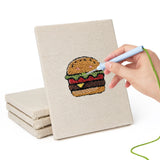 Hand punching one of the Fast Food Favorites mini canvases