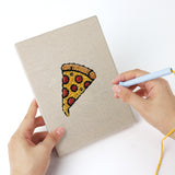 Punching a Fast Food Favorites mini canvas with the punch needle