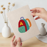 Hand holding a finished First Day Backpack mini canvas