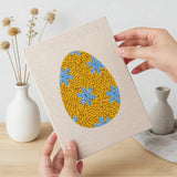 Hand holding a finished Floral Easter Eggs mini canvas