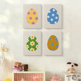 The four Floral Easter Eggs mini canvases on a wall above a shelf