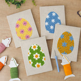The four finished Floral Easter Eggs mini canvases laid out on a table