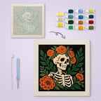 Flower Crown Skeleton canvas before and after punching, with the threads and tools