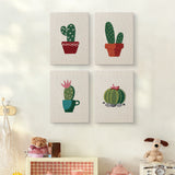The four Flowering Cacti mini canvases on a wall above a shelf