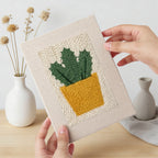 Hand holding a finished Flowering Cactus Pots mini canvas