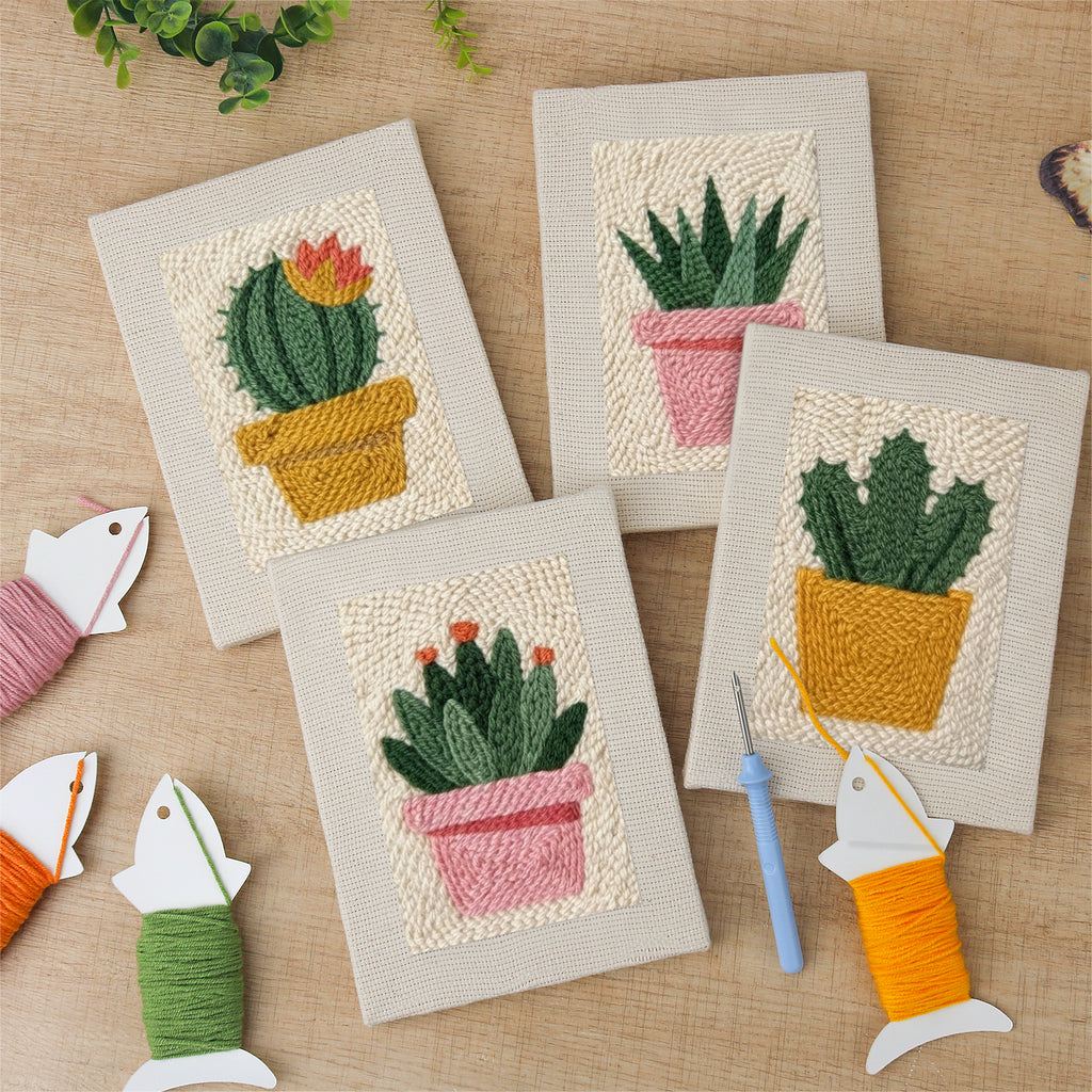 The four finished Flowering Cactus Pots mini canvases laid out on a table