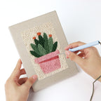 Punching a Flowering Cactus Pots mini canvas with the punch needle