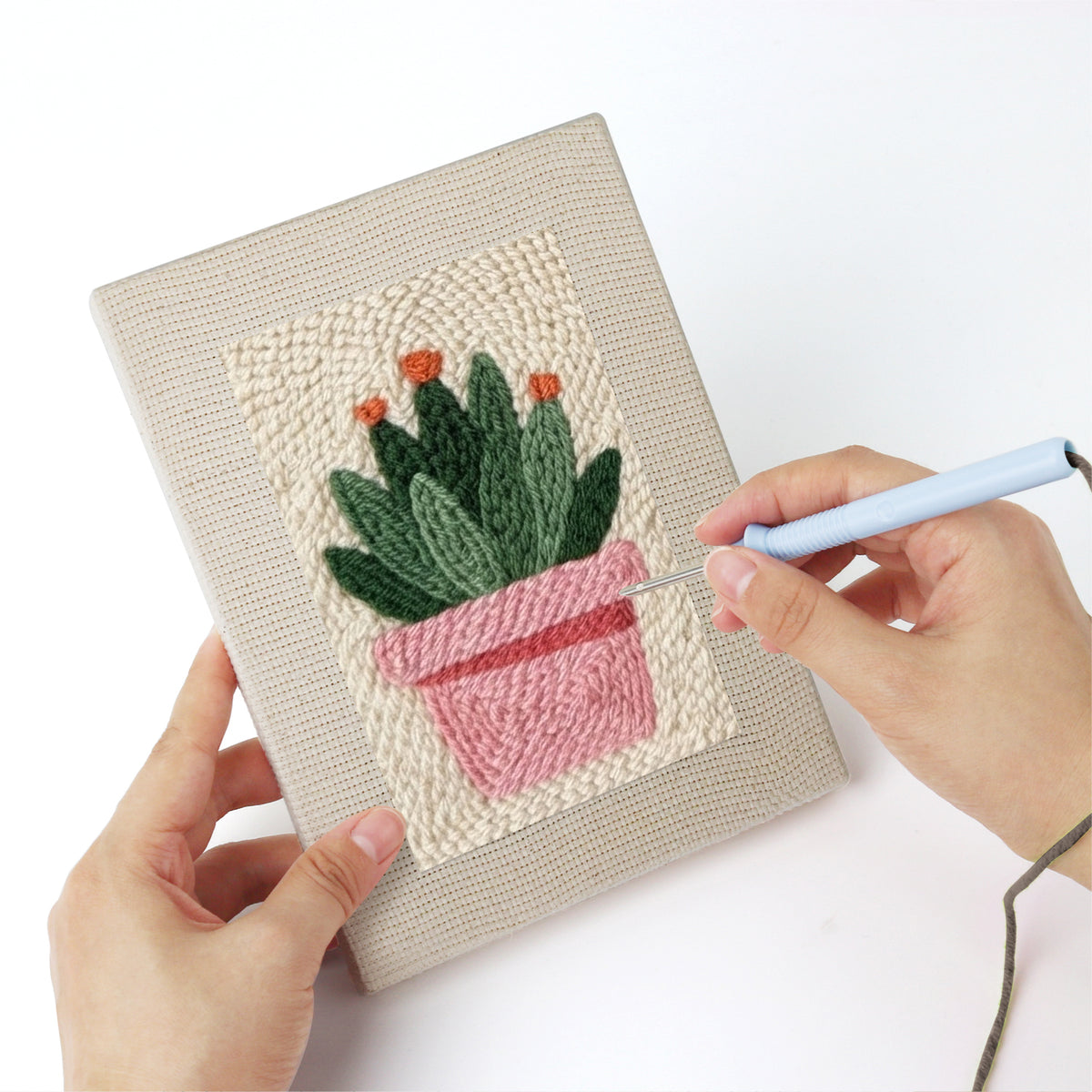 Punching a Flowering Cactus Pots mini canvas with the punch needle