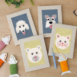 The four finished Fluffy Friends mini canvases laid out on a table