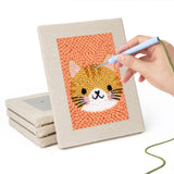 Hand punching one of the Fluffy Pet Portraits mini canvases