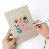 Punching a Folk Bunny Blooms mini canvas with the punch needle