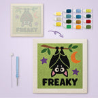 Freaky Bat canvas before and after punching, with the threads and tools