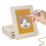 Hand punching one of the Frenchie and Bunny mini canvases