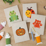 The four finished Frog and Ladybug mini canvases laid out on a table