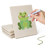 Hand punching one of the Frog and Ladybug mini canvases