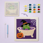 Frog Witch Bath canvas before and after punching, with the threads and tools